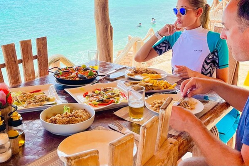 Dining on seafood spread at beachside restaurant Rancho Tipico Cueva de las Aguilas