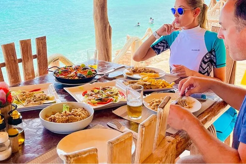 Baby Beach at Port Cabo Rojo, DR Dining on seafood spread at beachside restaurant Rancho Tipico Cueva de las Aguilas